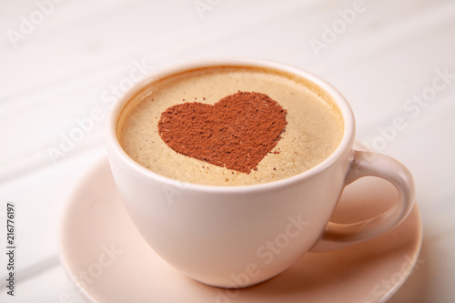 Cup of coffee with heart on foam morning coffee