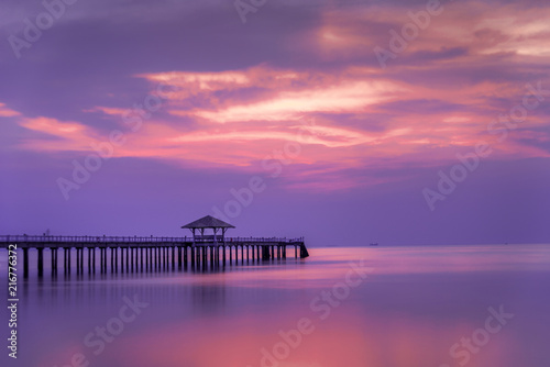 Wooded bridge in the port between sunrise..