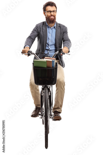 Young man riding a bicycle towards the camera
