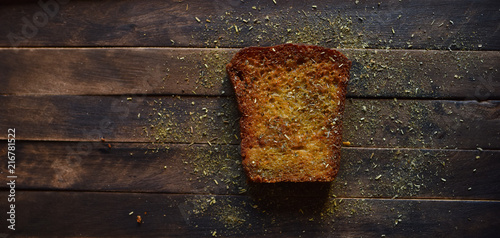 fried bread with spices on a dark wooden table
 photo