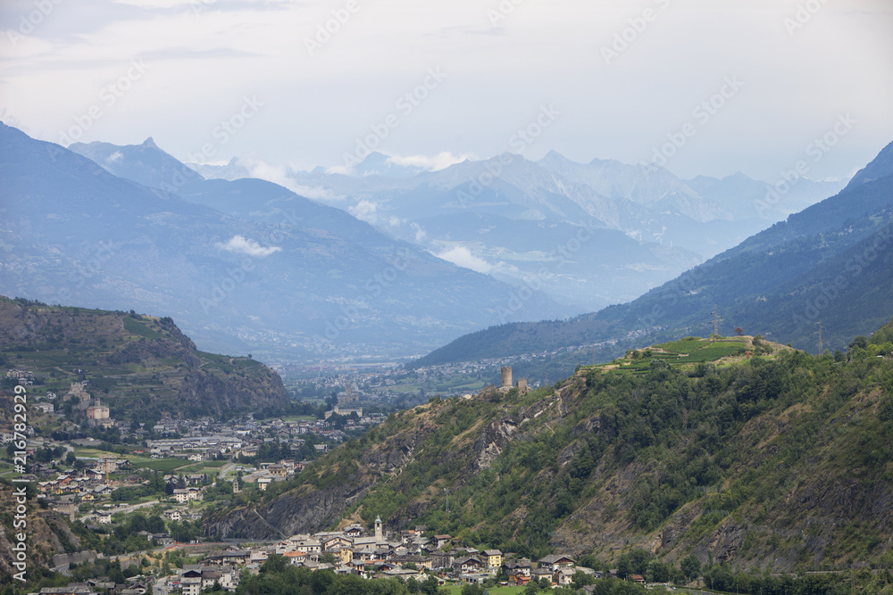 valley with city of sierre in swiss wallis with high snow capped mountains