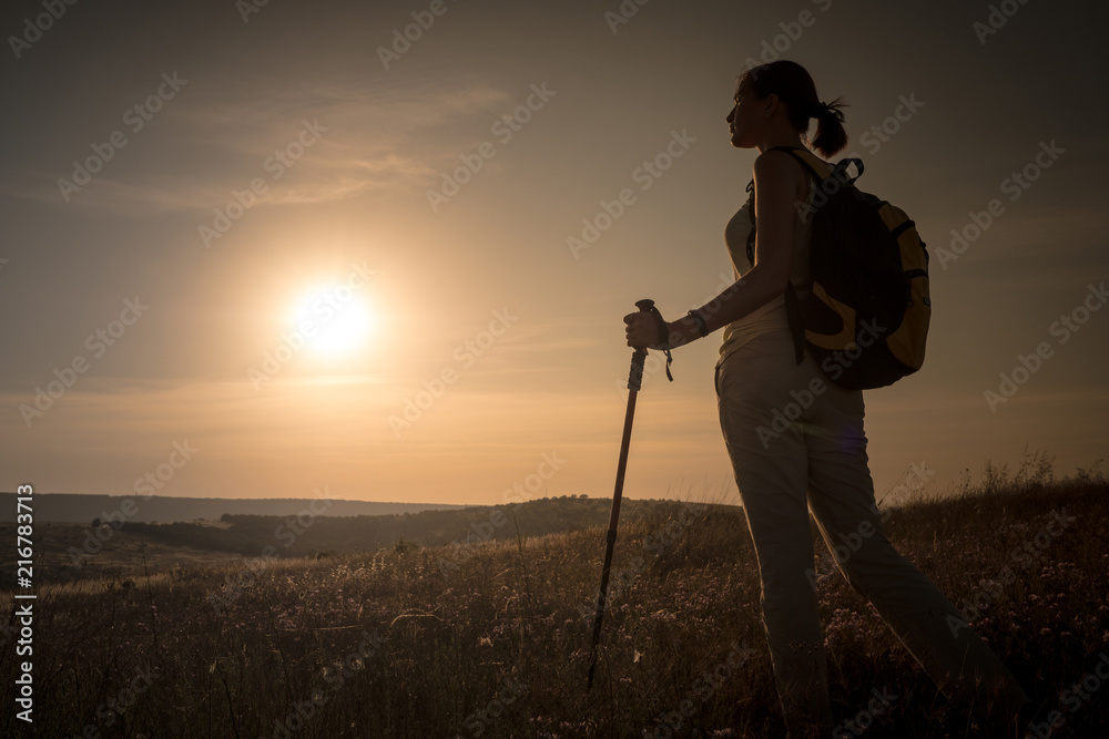 Silhouette hiker woman tracking with backpack