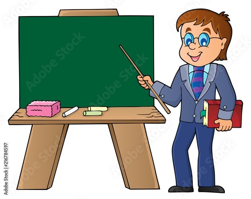 Man teacher standing by schoolboard
