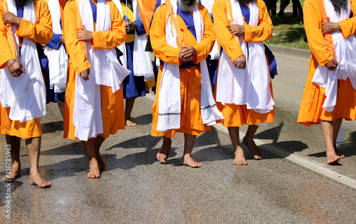 Sikh soldiers walk barefoot during a religious event