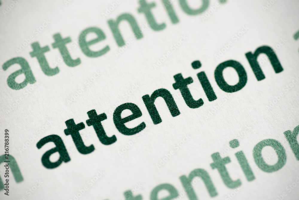 word attention printed on paper macro word attention printed on paper macro