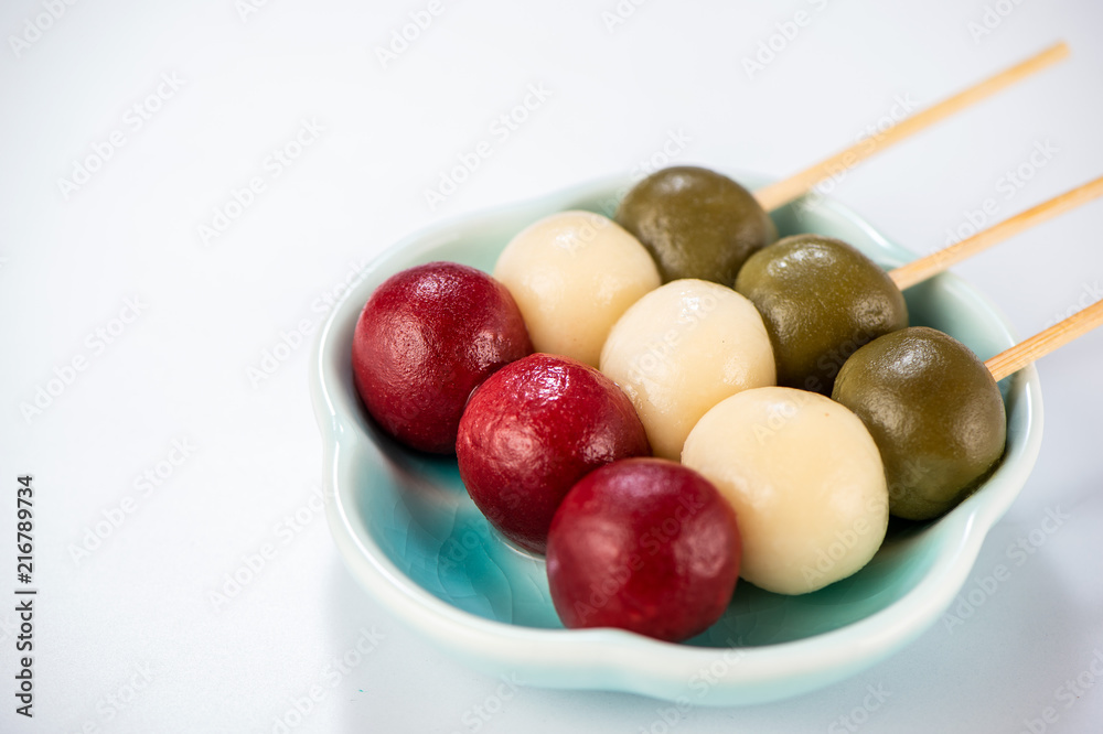 Japanese Dango dessert with 3 different color in pink(red), white, and green, recipe, hanami Dango, tsukimi Dango, copy space. Japanese Dango dessert with 3 different color in pink(red), white, and green, recipe, hanami Dango, tsukimi Dango, copy space.