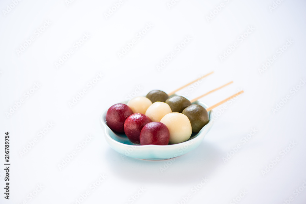 Japanese Dango dessert with 3 different color in pink(red), white, and green, recipe, hanami Dango, tsukimi Dango, copy space. Japanese Dango dessert with 3 different color in pink(red), white, and green, recipe, hanami Dango, tsukimi Dango, copy space.