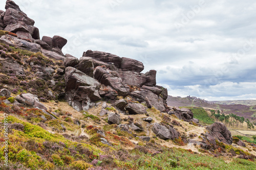 Rock formations at the Roaches, Peak District National park, view of the stones and fields on the background, selective focus