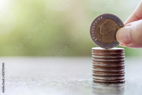 Hand putting a coin, 10 Bah...