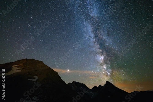 Astro night sky, Milky way galaxy stars over the Alps, Mars and Jupiter planet, snowcapped mountain range