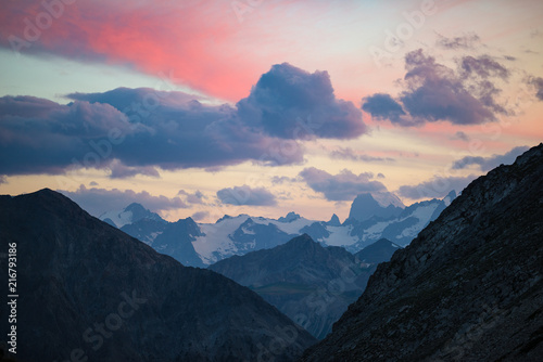Fototapeta Naklejka Na Ścianę i Meble -  The Alps at sunrise. Colorful sky majestic peaks, dramatic valleys, rocky mountains. Expansive view from above.