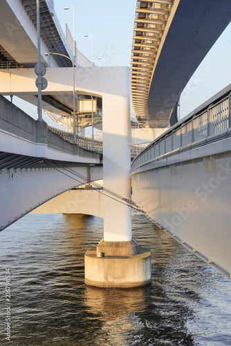 Pillar of Rainbow Bridge in the sea water of Odaiba Bay  Tokyo  Japan.