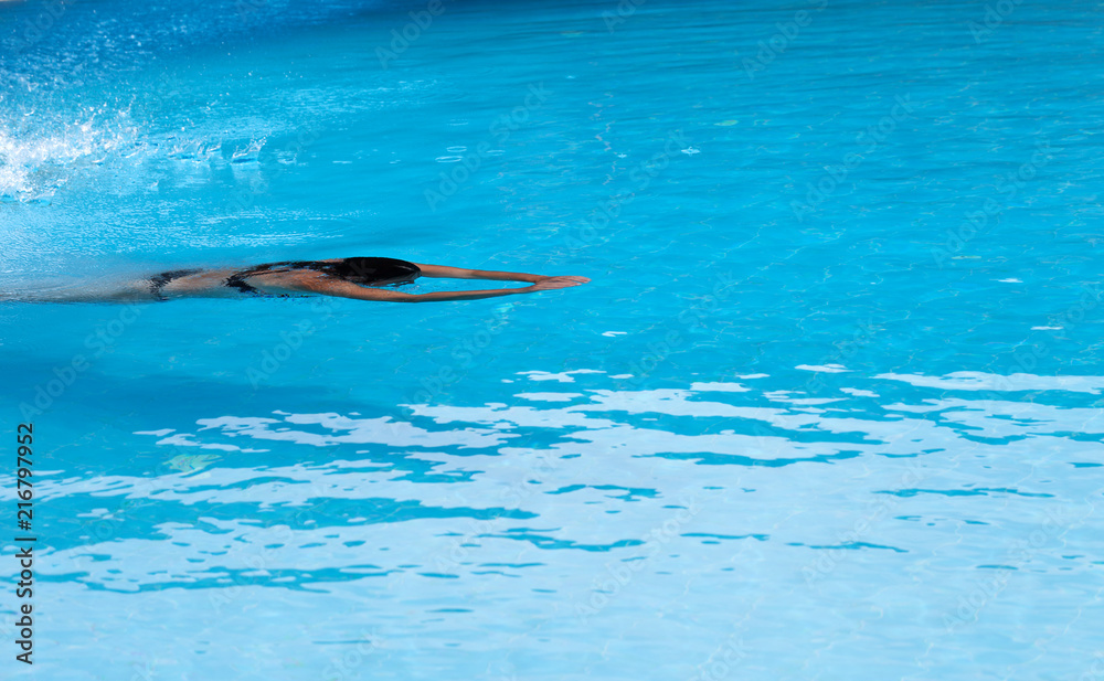Woman swimming in open air swim pool