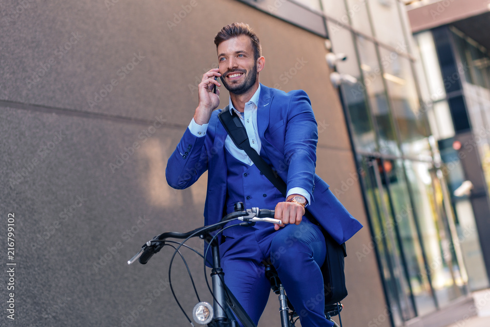 Young businessman going to work with his bicycle.