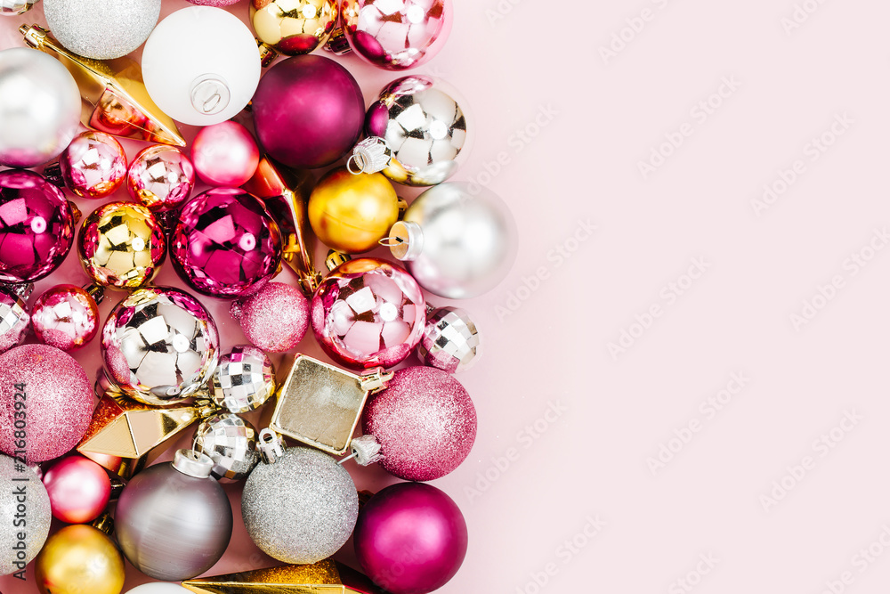 Holiday arrangement with Stylish Christmas shiny baubles and gold crystals on pastel pink background. Flat lay, top view Holiday arrangement with Stylish Christmas shiny baubles and gold crystals on pastel pink background. Flat lay, top view