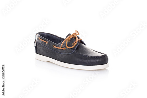 Close up of a blue mens top-sider boat shoes with white sole on white background with reflection. Fashion advertising shoes photos.