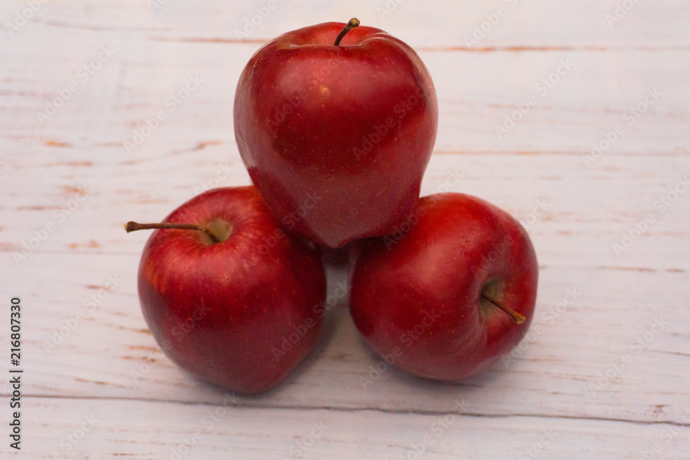 Red apples arranged on white wooden table Red apples arranged on white wooden table