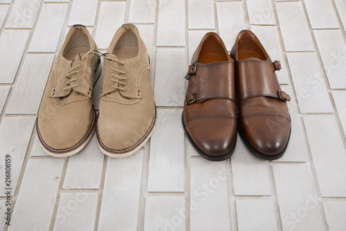 Set of mans fashion leather shoes on white brick wall