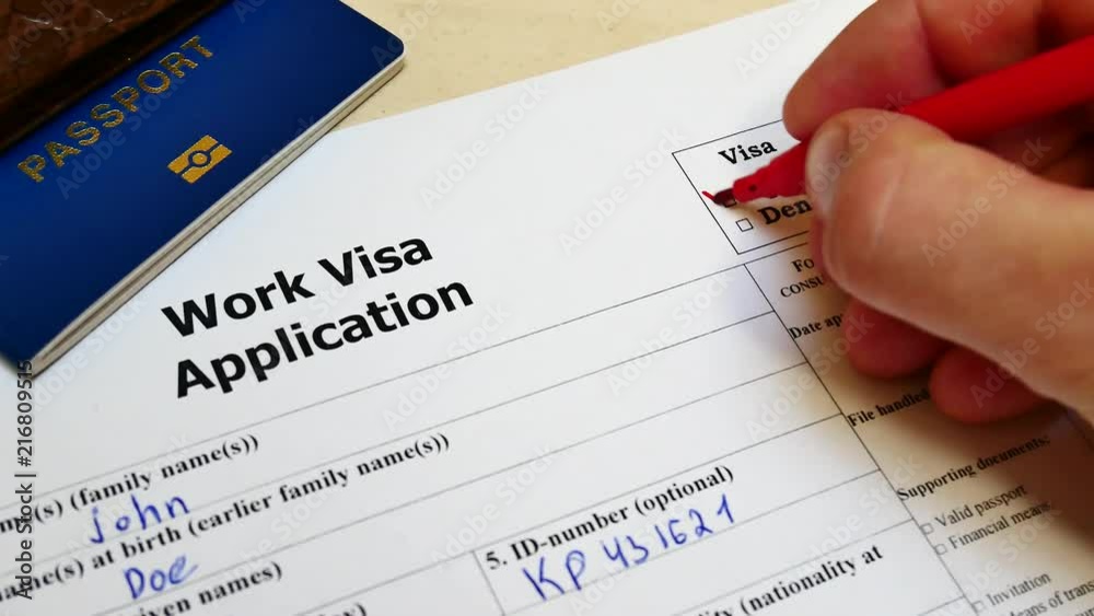 Decision to grant a Work Visa. Pen voting approved in checkbox in blank application form with passport and pen. Document with passport, apply and permission for foreigner country