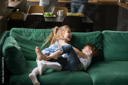 Foto Happy cute little boy and girl playing together at home, preschool kids sister a
