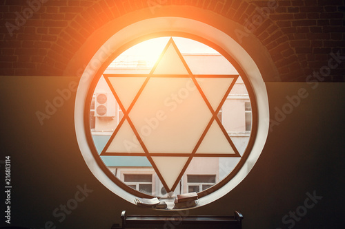 Window in synagogue in form of Star of David, six-pointed star with sunlight, Jewish symbol