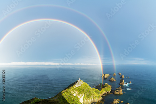 Double rainbow over Nugget Point lighthouse after the storm. Ahuriri Flat, Clutha district, Otago region, South Island, New Zealand. photo