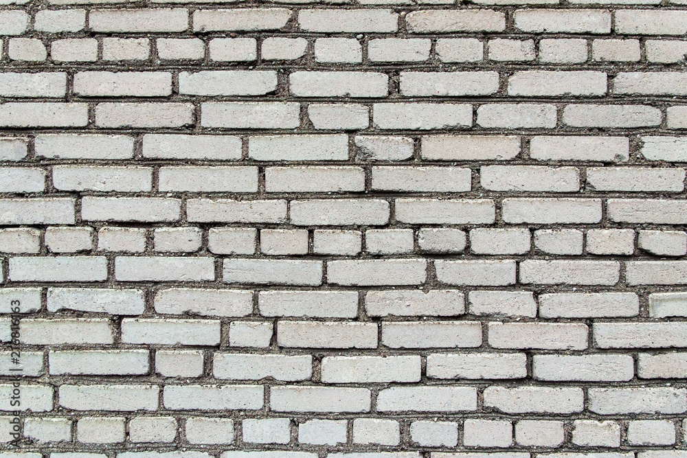 building construction: white brick wall texture - stained bricks bonded with cement