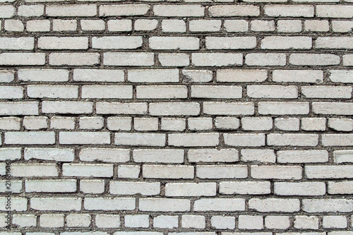 building construction: white brick wall texture - stained bricks bonded with cement