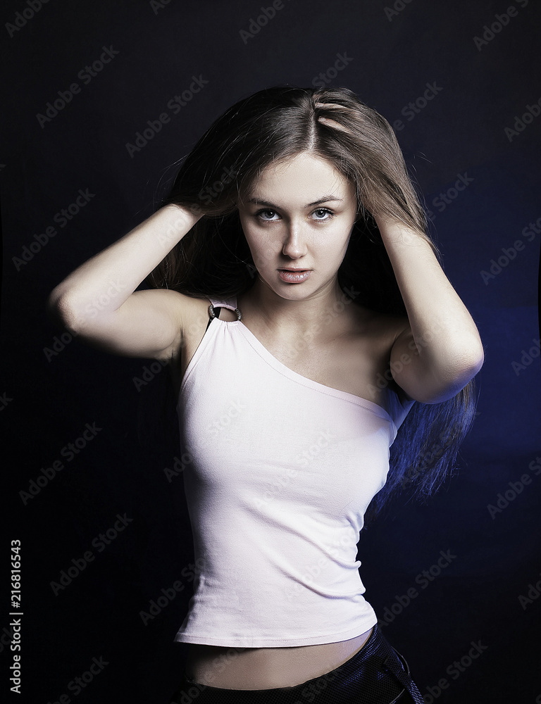 modern young woman with long hair posing for the camera modern young woman with long hair posing for the camera