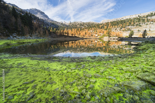 The green Fanes lake in Dolomites with autumnal coulors. Fanes valley, Badia Valley, Trentino, Italy. photo
