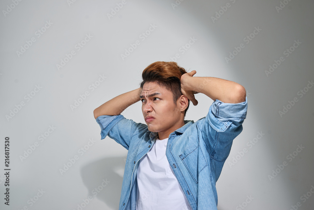 displeased man plugging ears with fingers doesn't want to listen isolated on gray wall background displeased man plugging ears with fingers doesn't want to listen isolated on gray wall background