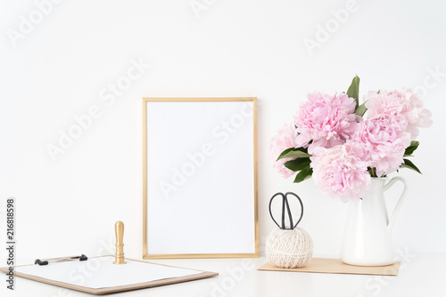 Vintage gold portrait a4 frame mock up with a bouquet pink peonies in white jug, gold stamp. Overlay your quote, promotion, headline, or design, great for businesses, bloggers and social media photo