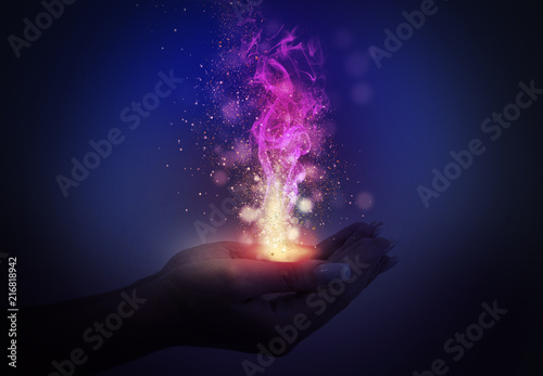 Magic emanating from the hands of a woman, light effect, glare of light, bokeh