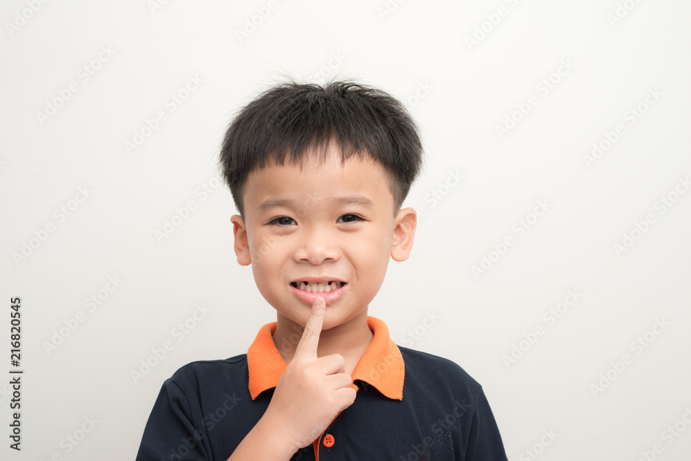 Young happy stylish boy with new tooth instead of missed baby teeth isolated on white background Young happy stylish boy with new tooth instead of missed baby teeth isolated on white background
