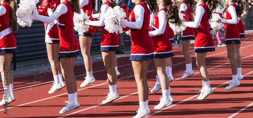 High school cheerleaders cheering during football game