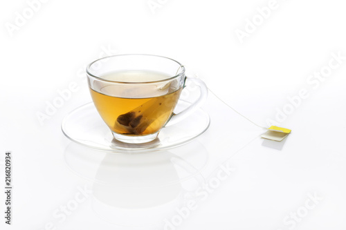 tea bag with glass cup isolated white.