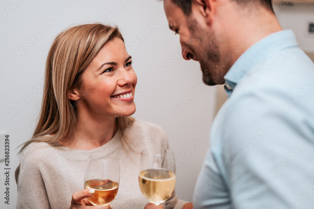 Close-up image of a couple celebrating with white wine. Close-up image of a couple celebrating with white wine.