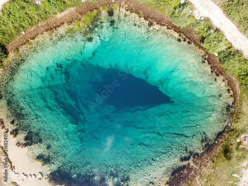 Fototapeta Naklejka Na Ścianę i Meble -  The spring of the Cetina River (izvor Cetine) in the foothills of the Dinara Mountain is named Blue Eye (Modro oko). Cristal clear waters emerge on the surface from a more than 100 meter-deep cave.