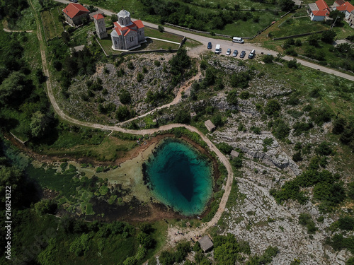 The spring of the Cetina River (izvor Cetine) in the foothills of the Dinara Mountain is named Blue Eye (Modro oko). Cristal clear waters emerge on the surface from a more than 100 meter-deep cave. photo