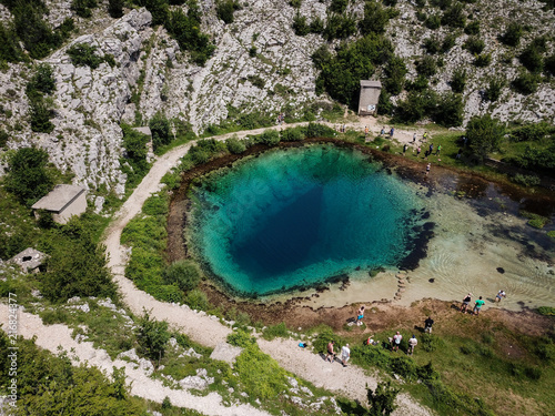 The spring of the Cetina River (izvor Cetine) in the foothills of the Dinara Mountain is named Blue Eye (Modro oko). Cristal clear waters emerge on the surface from a more than 100 meter-deep cave. photo