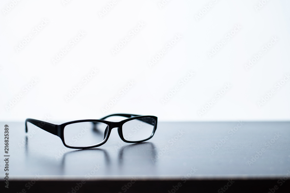 Glasses placed on the desk with white background