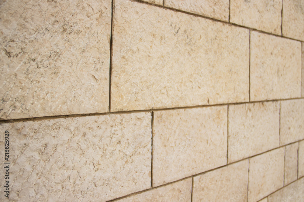 Fototapeta premium Wall of stones of different shapes of light shades