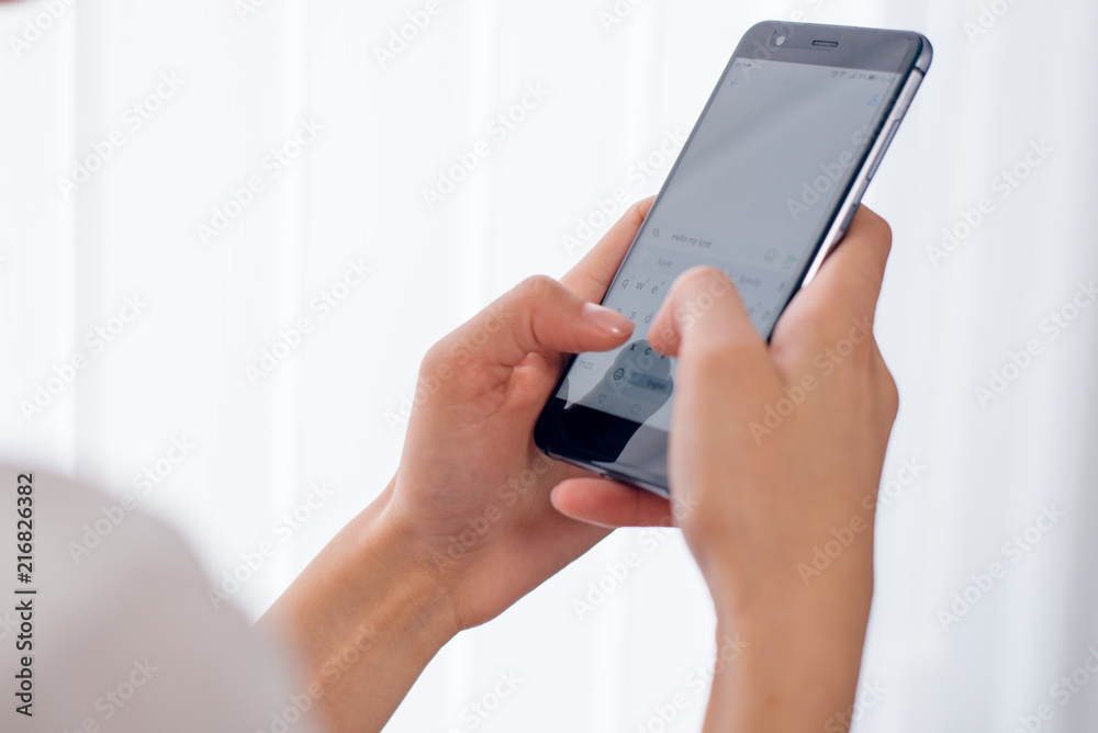 Closeup of Woman's Hand Using Smart Phone at office Closeup of Woman's Hand Using Smart Phone at office