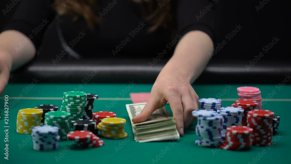 Female checking hand and putting money and house key on table, bluff, confidence Female checking hand and putting money and house key on table, bluff, confidence