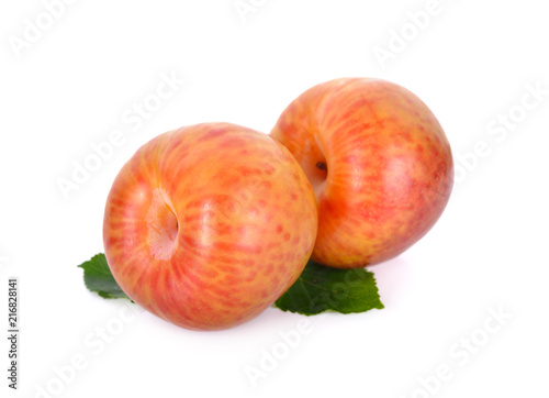 whole fresh pluot on white background