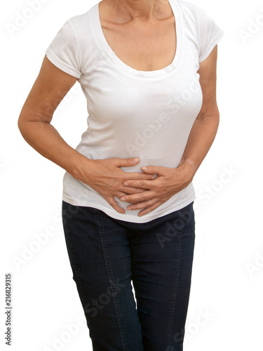 Unidentifiable older, mature woman with stomach pain, isolated on white background. Cramps, constipation etc. © Mushy