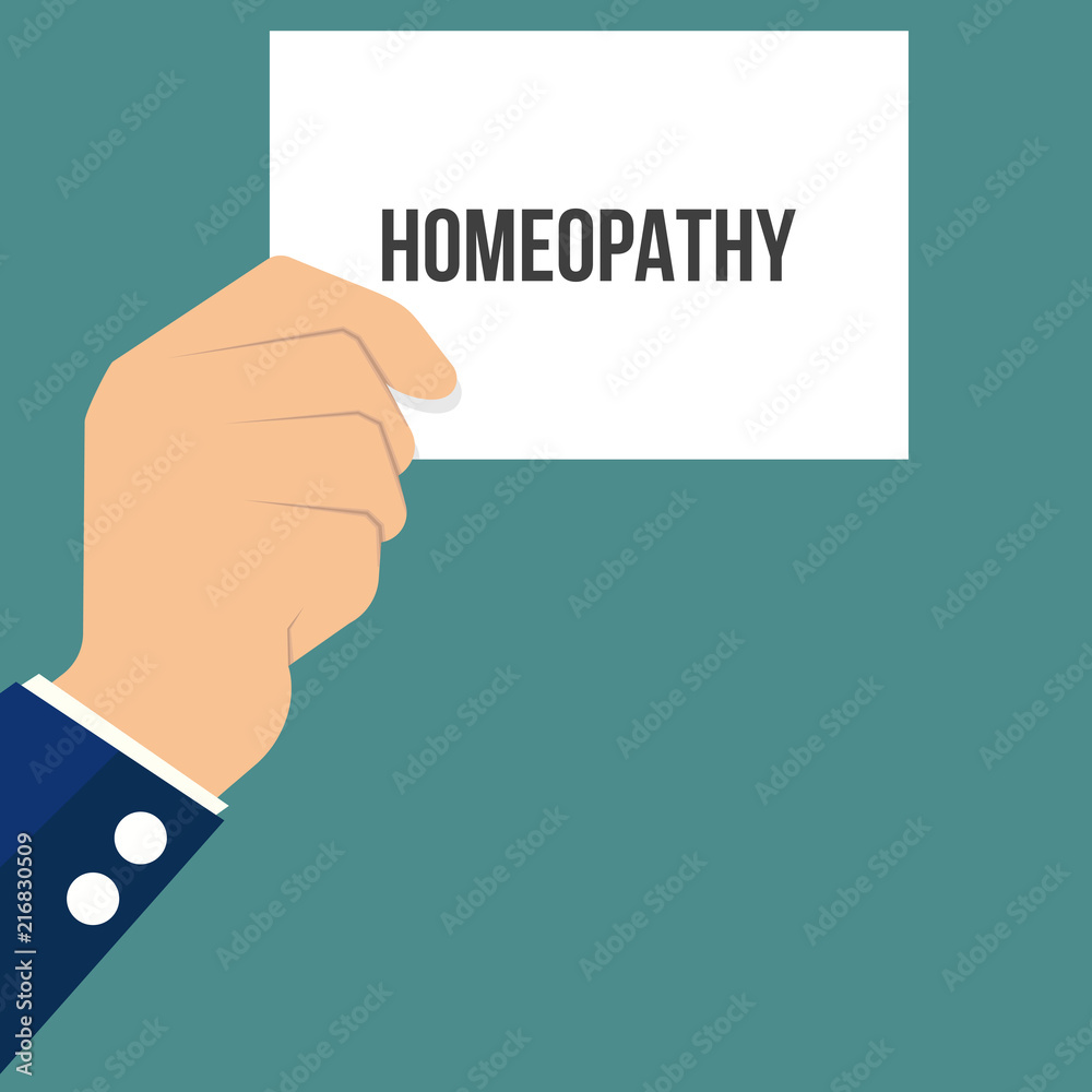 Man showing paper HOMEOPATHY text Man showing paper HOMEOPATHY text