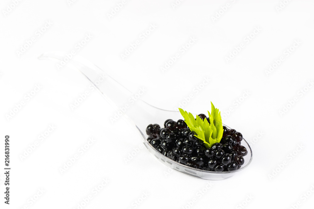 Plastic spoons with fish caviar on a white background. Plastic spoons with fish caviar on a white background.