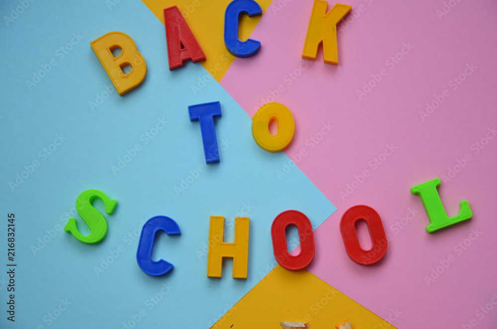 School office supplies with copy space. Back to school text concept. inscription flattering back to school on a colorful bright abstract Top view. School office supplies with copy space. Back to school text concept. inscription flattering back to school on a colorful bright abstract Top view.