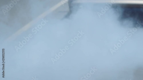 Exit the smoke from the exhaust pipe of the car. The car smokes